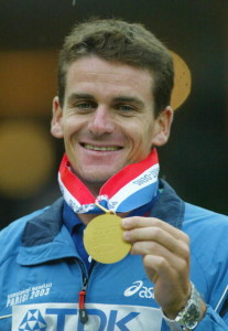 PARIS - AUGUST 29:  Giuseppe Gibilisco of Italy celebrates with his gold medal after winning the men's pole vault at the 9th IAAF World Athletics Championship at the Stade de France on August 29, 2003 in Paris.  (Photo by Phil Cole/Getty Images)